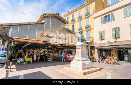 day view of roofed market hall with unidentified tourists in Antibes, France. Stock Photo