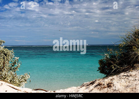 Pristine turquois waters through gap in the dunes at Ningaloo reef Western Australia Stock Photo