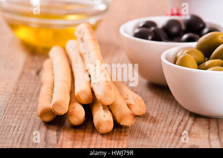 Grissini breadsticks with ham and olives. Stock Photo
