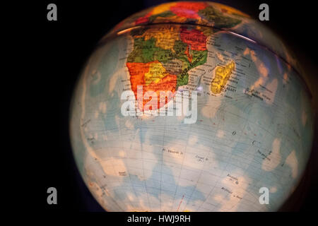 close up of old fashioned world globe a ball shaped map lit from within focusing on South Africa Stock Photo