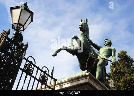Naples, Italy. The Bronze Horses or Russian Horses are two monumental equestrian sculptures representing two horses rampant tamed by two grooms. In 1846 Tzar Nicholas I and his wife Aleksandra Fёdorovna on a visit to Naples city, donated the statues to king Ferdinando II Borbone and his wife Maria Theresa of Austria. Stock Photo