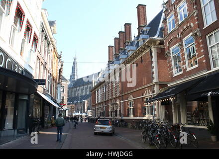 Zijlstraat, main shopping street in Haarlem, Netherlands. In background the 14th century City Hall (Stadhuis van Haarlem) Stock Photo