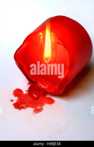 fallen over, burning candle Stock Photo