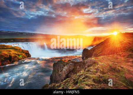 Godafoss waterfall at sunset. Fantastic landscape. Beautiful cumulus clouds. Iceland, Europe