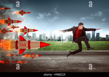 Asian business man jump from tax rocket. Tax escape concept