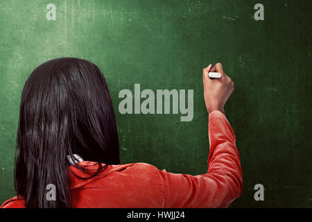 Asian woman drawing something on the blackboard. You can put your message on it Stock Photo