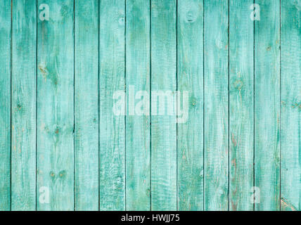 Wooden background from the boards painted blue color. Boards are stayed vertically. Paint has cracked from time. Stock Photo