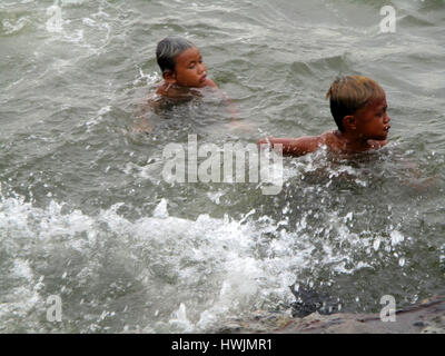 Manila, Philippines. 21st Mar, 2017. Filipino boys bathe along the ...