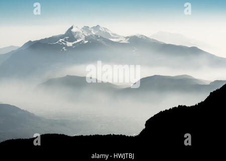 Spectacular view of mountain ranges silhouettes and fog in valleys. Stock Photo