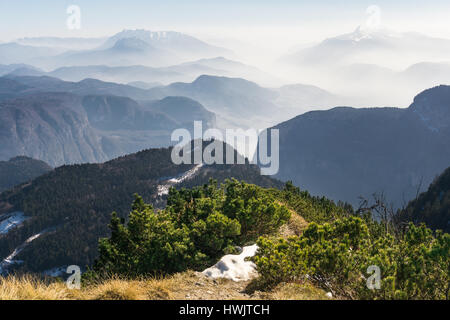 Spectacular view of mountain ranges silhouettes and fog in valleys. Stock Photo