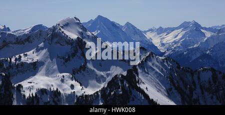 Mount Rophaien and other snow covered mountains seen from mount Fronalpstock. Stock Photo