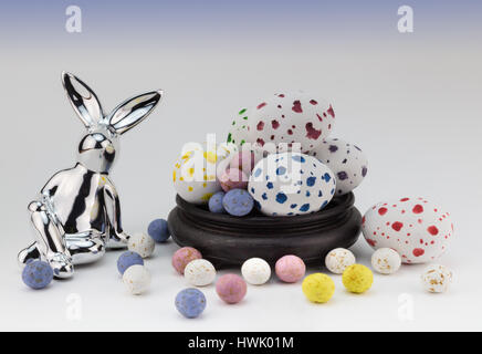 Easter egg background with silver rabbits and speckled easter eggs on white Stock Photo