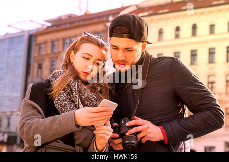 tourists couple tries to find the way on smart phone navigation app Stock Photo
