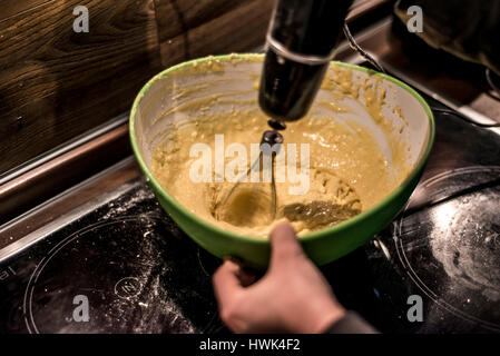 hands making duff pastry of egg in bowl to make fresh waffles Stock Photo
