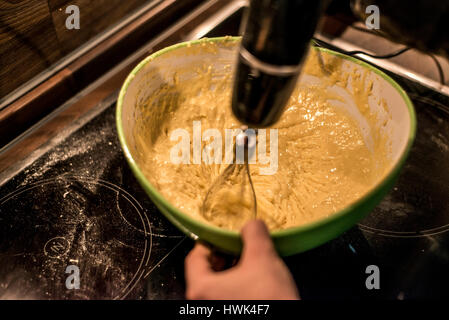 hands making duff pastry of egg in bowl to make fresh waffles Stock Photo