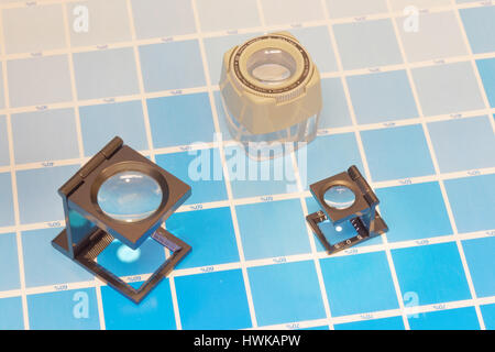 Magnifier or printer's loupe sits on a cyan test sheet in a pre-press ...
