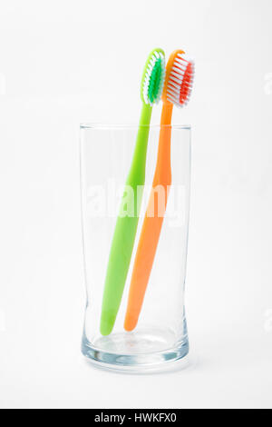 toothbrushes in glass isolated on white Stock Photo