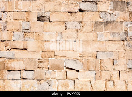 old stone wall made with big blocks, light brown color, beautiful texture and big size photo Stock Photo