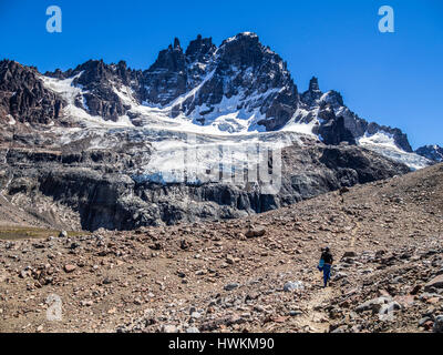 Hiker on the trail to the lagoon below mountain Cerro Castillo,nature reserve Cerro Castillo, Reserva Nacional Cerro Castillo, Aysen region, Patagonia Stock Photo