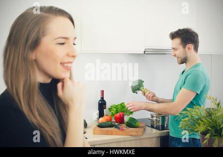 Young couple spends time together in the kitchen. lifestyle couple kitchen cooking home happy breakfast young concept Stock Photo