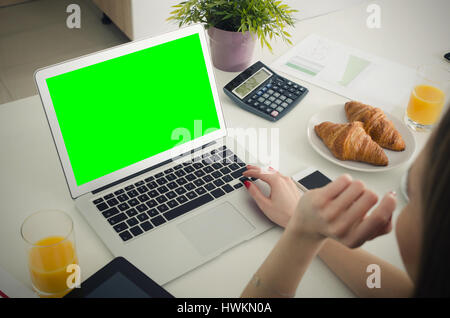 Woman using laptop in home. laptop work green blank display isolated website desk concept Stock Photo