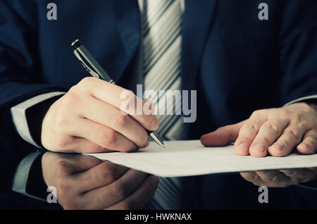 Businessman signs a contract. man contract signing hand writing pen letter paper concept Stock Photo