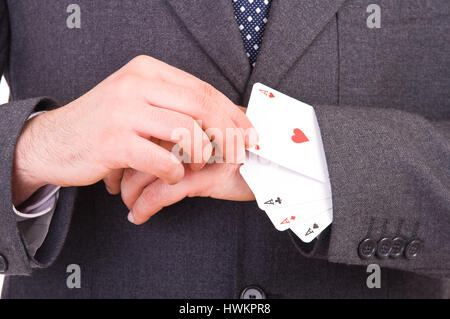 Businessman with playing cards hidden under sleeve. Stock Photo