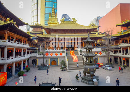 SHANGHAI, CHINA - 29 JANUARY, 2017: Religious alter in yellow and red colored theme, golden buddha statue standing at center, located at Jing'an temple traditional chinese neighborhood Stock Photo