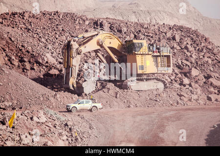 Big shovel loading of copper ore near to pickup truck Stock Photo