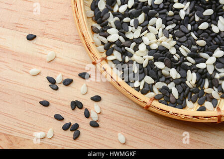 Black and white sesame seed in bamboo basket Stock Photo