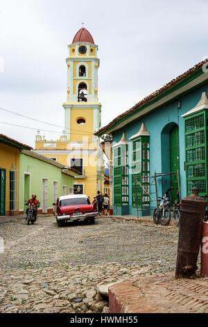 Trinidad, Cuba - January 14, 2016: Typical scene of one of streets in the center of Trinidad, Cuba - colonial architecture, people walking around, vin Stock Photo