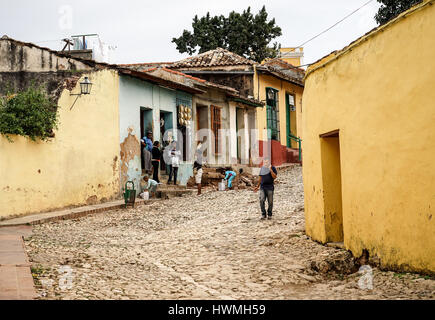 Trinidad, Cuba - January 14, 2016: Typical scene of one of streets in the center of Trinidad, Cuba - colonial architecture, people walking around, Stock Photo