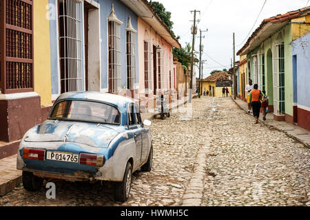 Trinidad, Cuba - January 14, 2016: Typical scene of one of streets in the center of Trinidad, Cuba - colonial architecture, people walking around, vin Stock Photo