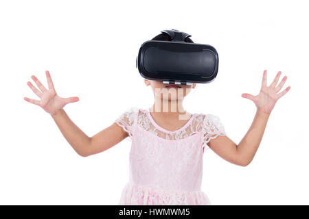 Asian Chinese little girl experiencing virtual reality in isolated white background. Stock Photo
