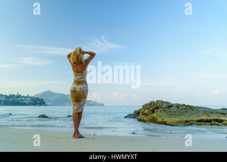 Woman on the beach in Surin Phuket Thailand Stock Photo