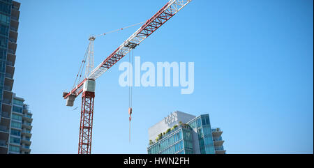 Studio Shoot of a crane  against low angle view of skyscrapers Stock Photo