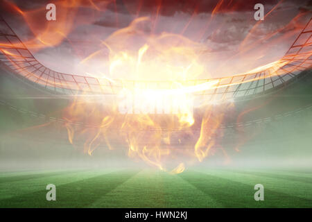 Ball of fire against misty football stadium under floodlights 3d Stock Photo