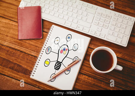 Composite image of light bulb connected with various icons against white background against notepad, keyboard passport and keyboard Stock Photo