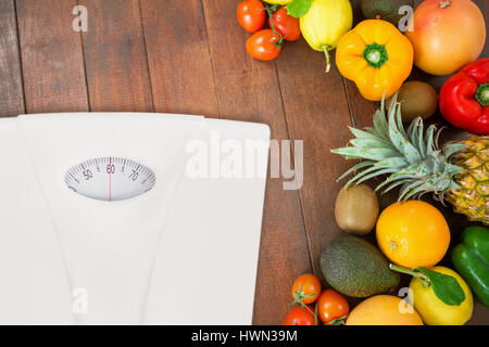 weighting scale against overhead view of assortment of fresh fruits Stock Photo