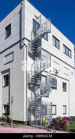 Textures of the city - Modern residential building with exterior spiral staircase. Stock Photo