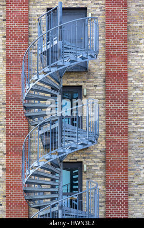 Structures of the city - Spiral staircase at the exterior of an modern building. Stock Photo