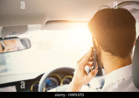 Men driving a car with his phone Stock Photo