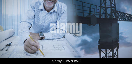 Studio Shoot of a part of a crane  against orange and blue sky with clouds Stock Photo