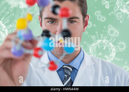 Young scientist experimenting molecule structure against digitally composite image of virus 3d Stock Photo