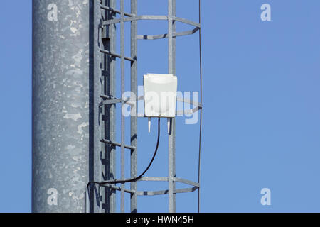 Wifi antenna outdoor on a metal light pole with blue sky background Stock  Photo - Alamy