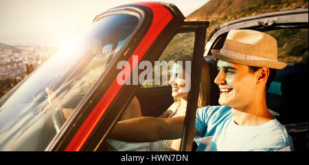 Side view of smiling couple on their way to beach in classy car Stock Photo