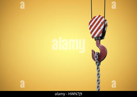 Studio Shoot of a crane lifting hook against yellow vignette Stock Photo