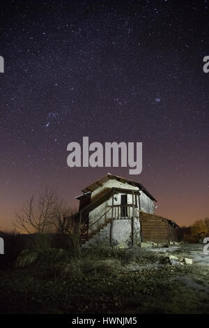 Old house under a bright night sky filled with stars Stock Photo - Alamy