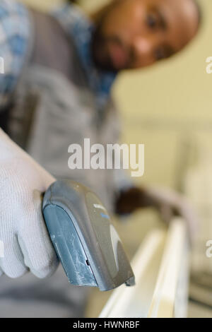 Closeup of man using handheld scanner Stock Photo