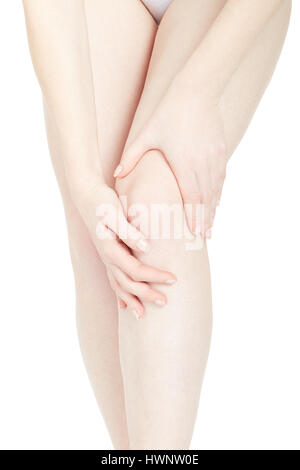 Woman touching her fatigued legs isolated on white, clipping path Stock Photo
